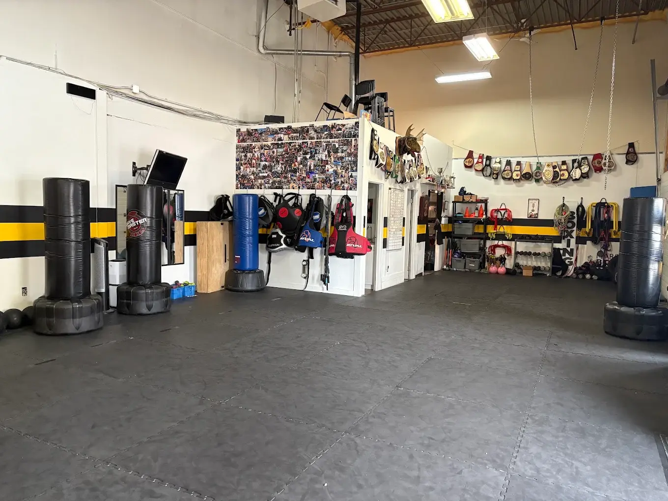 The club’s training floor, boxing equipment and championship belts
