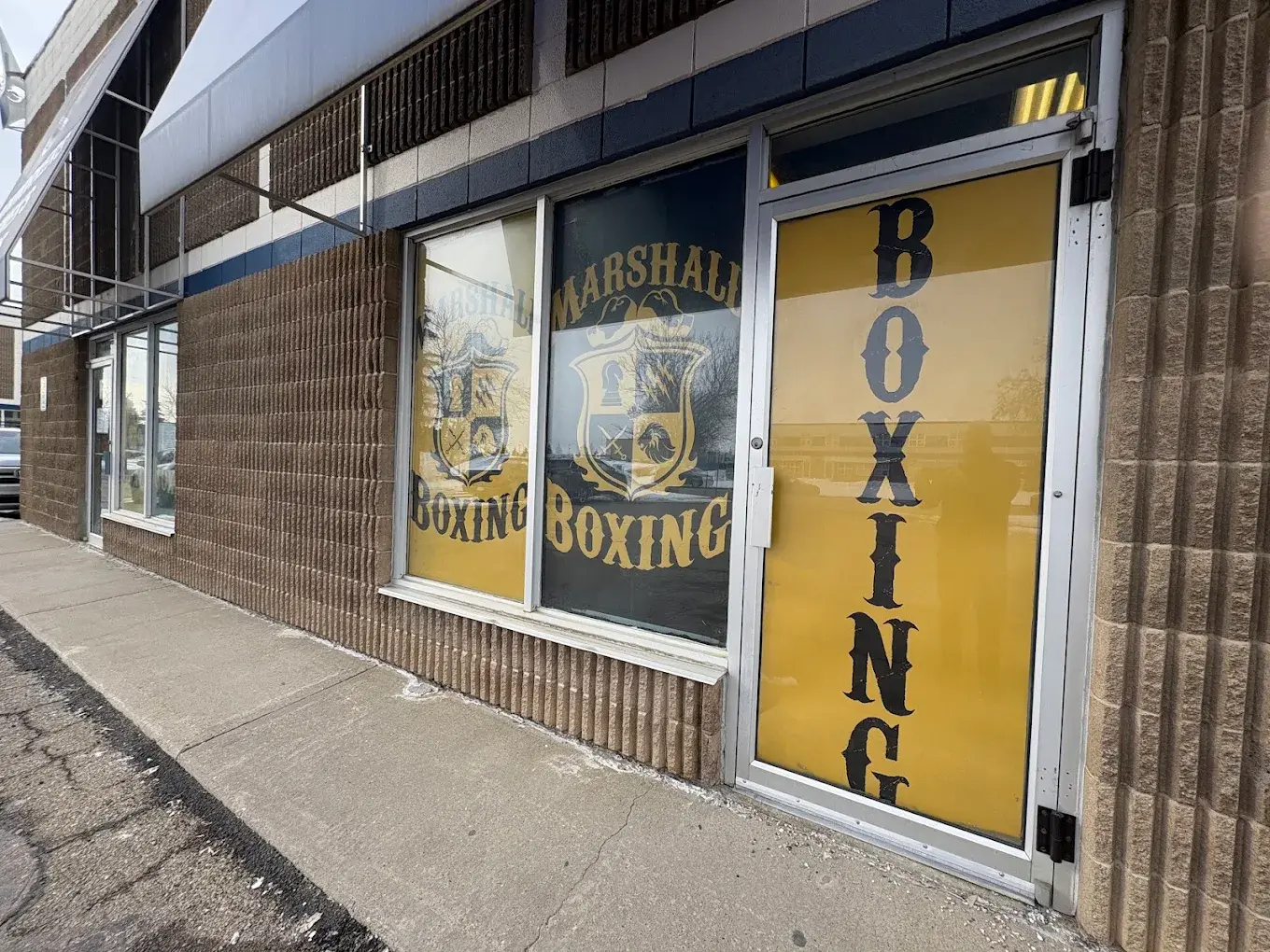 Marshall Boxing Club’s black and gold entrance on Chisholm Avenue